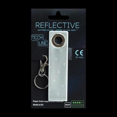 Odblaskowy breloczek Tech Line - Biały pasek. Wydawca: MG. SmakLiter.pl Opakowanie Odblaskowy breloczek Tech Line - Biały pasek