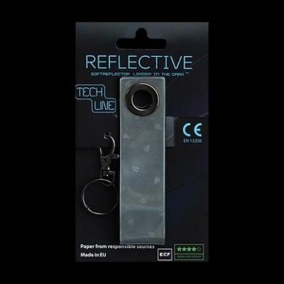 Odblaskowy breloczek Tech Line - Czarny pasek. Wydawca: MG. SmakLiter.pl Opakowanie Odblaskowy breloczek Tech Line - Czarny pasek