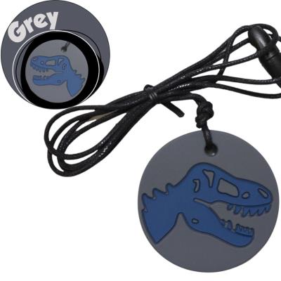 Opakowanie Gryzak antystresowy naszyjnik - dinozaur szary