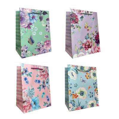 Torebka prezentowa uniwersalna M Kwiaty brokat mix. Wydawca: JU-PITER. SmakLiter.pl Opakowanie Torebka prezentowa uniwersalna M Kwiaty brokat mix