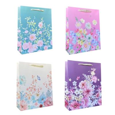 Torebka prezentowa uniwersalna S Kwiaty brokat mix. Wydawca: JU-PITER. SmakLiter.pl Opakowanie Torebka prezentowa uniwersalna S Kwiaty brokat mix