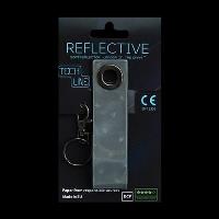 Odblaskowy breloczek Tech Line - Czarny pasek. Wydawca: MG. SmakLiter.pl Opakowanie Odblaskowy breloczek Tech Line - Czarny pasek